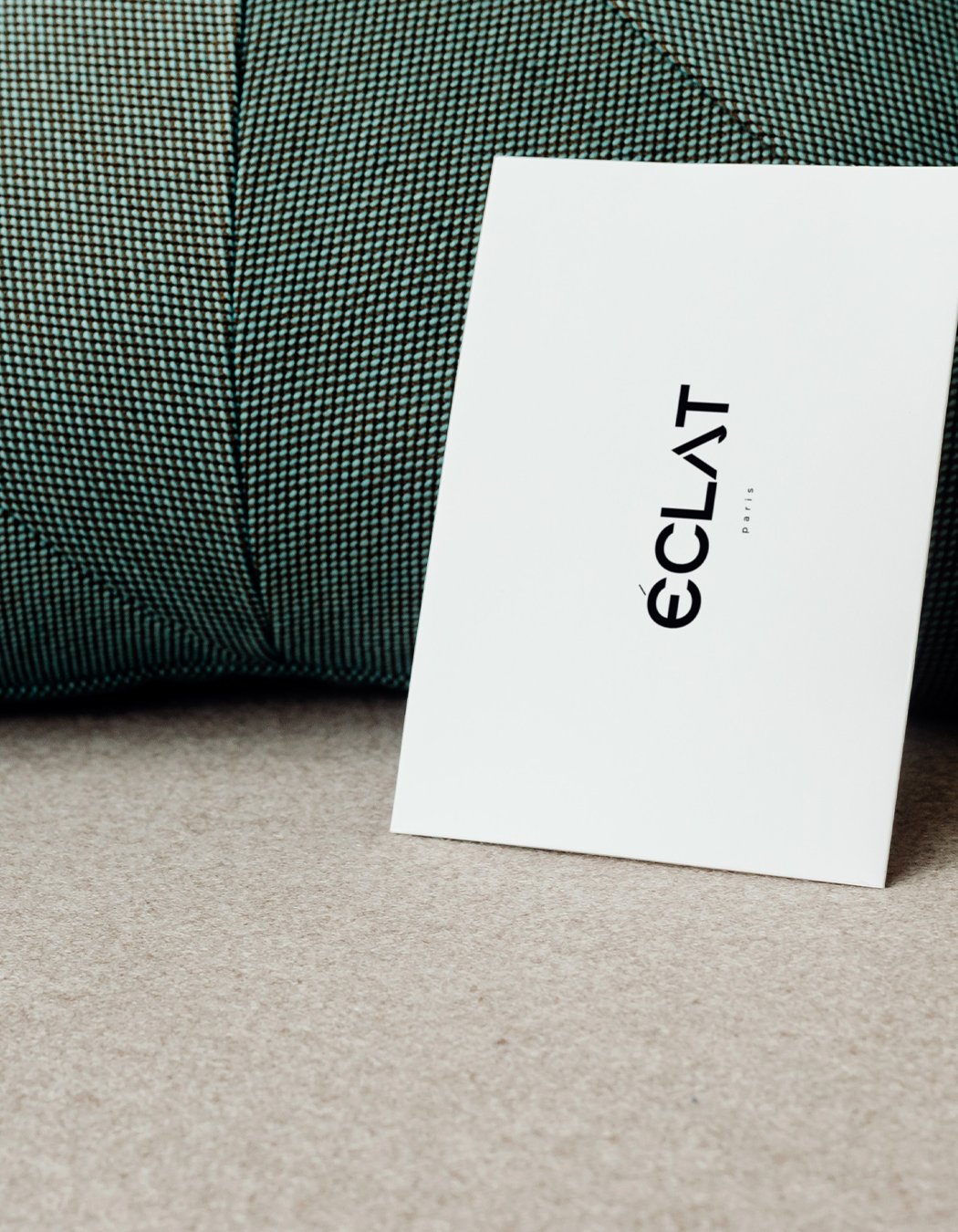 Éclat card on textured sofa